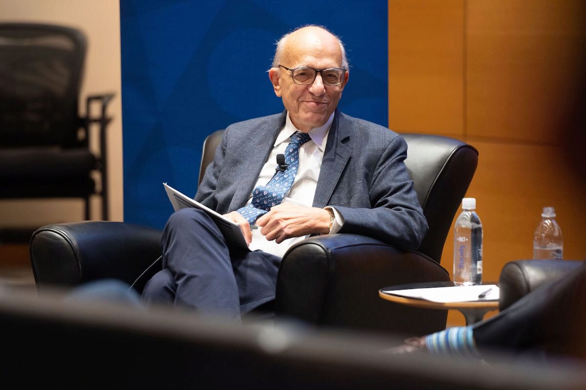 Professor Jeremy Siegel smiles and sits with crossed legs