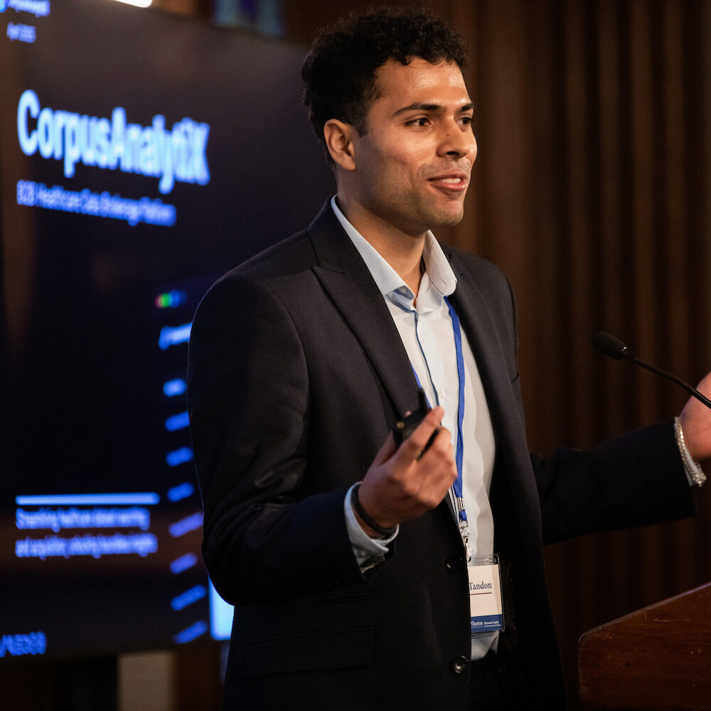 A speaker at a podium at Demo Day